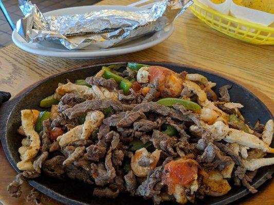 beef chicken, shrimp, with onions, green peppers, mildly seasoned, with hot flour tortillas in the foil to keep them warm.