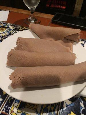 Injera bread that comes with the meal to tear and pick up food with ur hands.