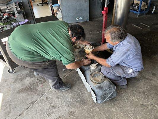 Mechanic Frank (on left) and shop owner Bruce (right) changing a fuel pump on a Dodge RAM.