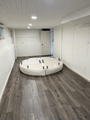 Basement bedroom renovation with new luxury vinyl floor and beadboard ceiling