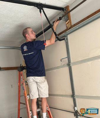 #1 Garage Door Technician working on Torsion Spring and Torsion Tube