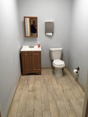 Porcelain tile that resembles old wood brings a certain charm to what was a dull bathroom. Garfield Heights, OH