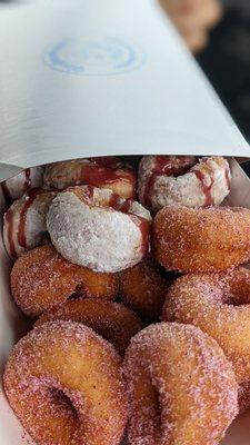 Raspberry sugar donuts and powdered donuts with raspberry drizzle.