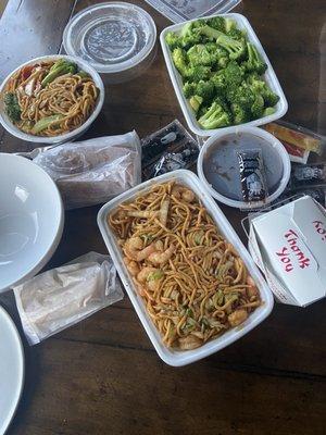 Steamed broccoli with brown sauce and rice, veggie and shrimp lo mein, spring rolls, and egg rolls