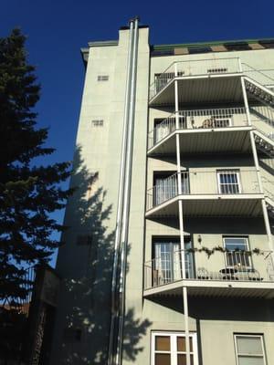 Dual chimney to accommodate numerous boilers and water heaters.