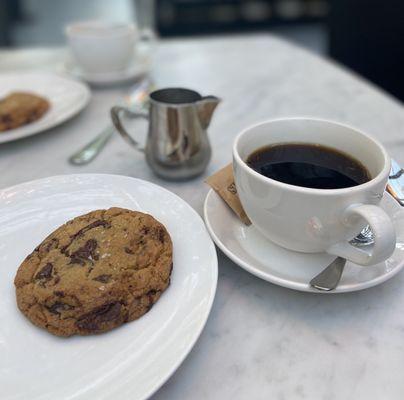 Made to order warm chocolate chip cookie with a delicious cup of drip coffee