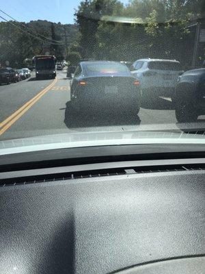 Double-parked Tesla on Carlmont Drive this afternoon. There's no way around these people.