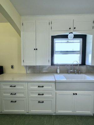 Kitchen in a 1928 yr old home: added 3/4 new cabinets mixed with existing uppers. Repaint for seamless look between old & new.