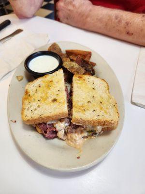 Ruben sandwich with lemon pepper fried potatoes.