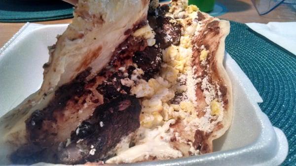 Baleada con carne asada. That's a flour tortilla filled with steak, cheese, cream, scrambled eggs, and refried beans.