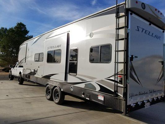 Super excited with our purchase from i-15RV. Backing up our new 5th wheel toy hauler into it's new home.