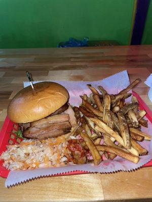 Pork Belly Sandwich with stuff on the side. Four meaty pieces of pork belly on a brioche bun. Fries are fan-tas-tic!!