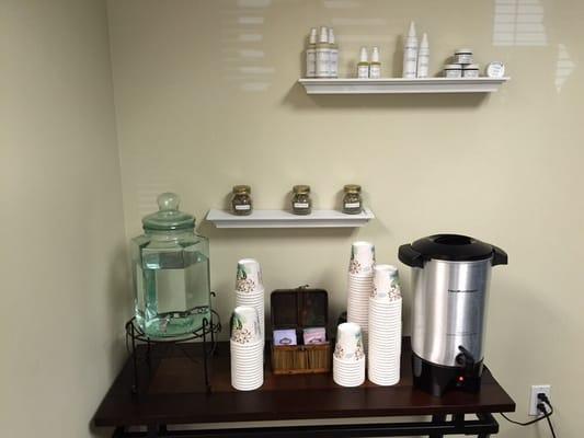 Hydrating tea station with natural facial products displayed on top