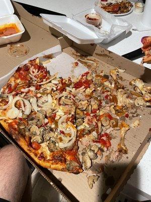 Monster pizza drowned in toppings