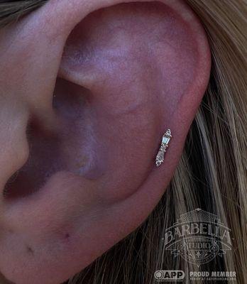 Fresh helix piercing with Buddha Jewelry's, "Idolized" in yellow gold. Pierced by Cat, styled and photographed by Ariel!