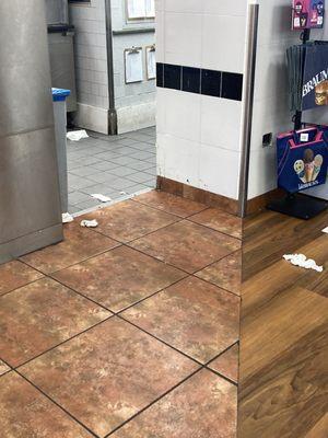 Floor from kitchen into public area. Trash all over the floors.