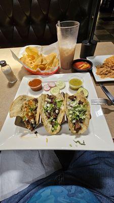 Tacos de carne asada, frijoles refrritos, chips & salsa, horchata & rice.