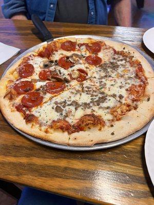 A medium with pepperoni and mushrooms, and ground beef toppings.