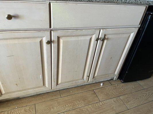 Rusty kitchen counter with only a sink on top and fridge to the side.