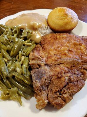 Pork chop plate, green beans, rice & gravy, corn muffin (close-up)