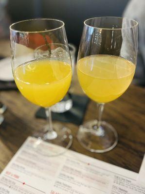 Two mimosas; pineapple and orange