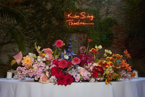 Wedding Reception with multicolored florals at Kim Sing Theatre. Florals by Lovesome Blossoms.