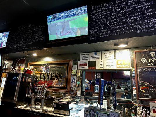 View of beer menu and TV's at the bar