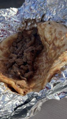 Water down beans on a soggy tortilla, meat had off flavor, very undercooked and tough.