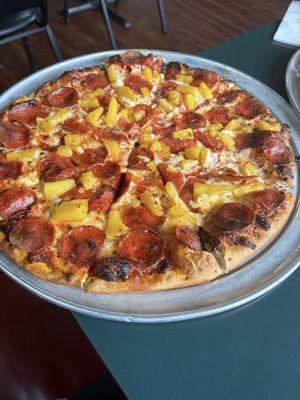 Pepperoni and pineapple on thin crust. Delicious