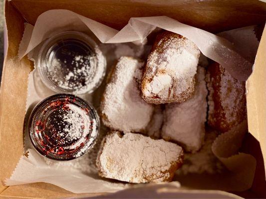 Beignets with berry and chocolate sauces