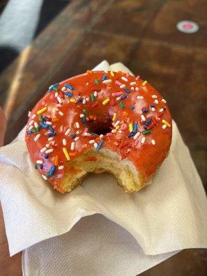 Strawberry frosted donut with sprinkles