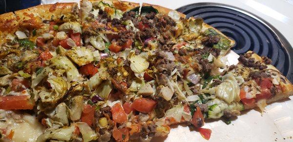 My vegetarian pizza with hamburger sprinkled all over it.