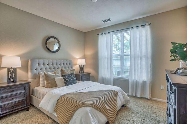 a bedroom with a large bed and a window at Spring Creek Apartments