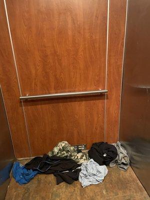 Extremely soiled clothing left in only working elevator.