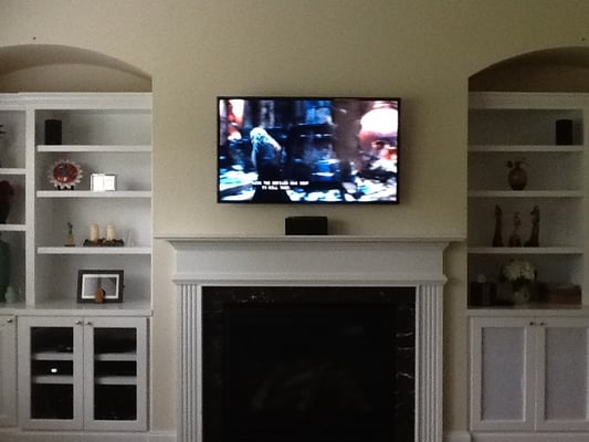 Fireplace TV mounting & 5.1 surround sound system with all components hidden in bookshelves