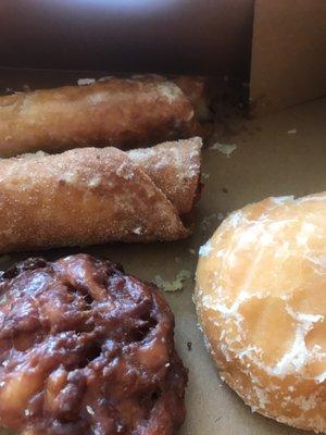 Fried tortilla confections on the top left: one is berry the other is apple cinnamon. Also pictured is an apple fritter and a lemon filled.