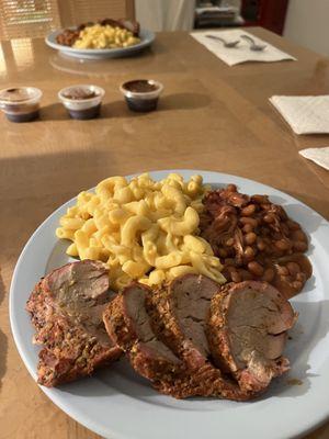 Slices of tenderloin, beans and Mac and cheese.