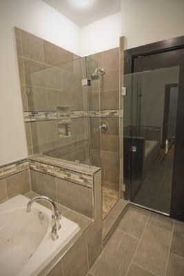 The wall dividing the shower and tub used to extend to the ceiling. This was cut down and replaced with glass.