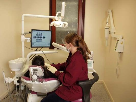 Dental hygienist Sasha with one of her patients. Sasha is just one of the excellent dental professionals in our office.