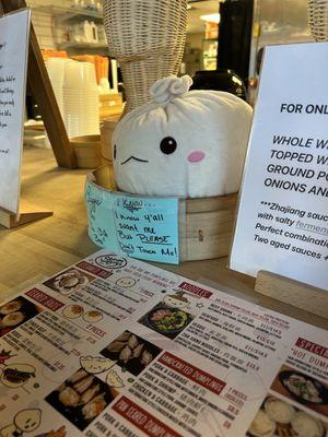 The front with the menu displayed featuring the cutest plush!