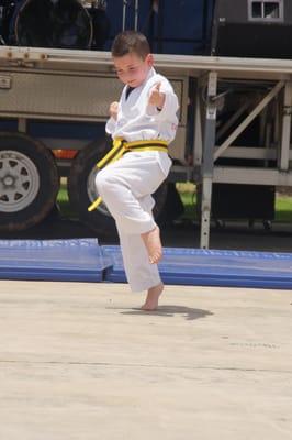 Here is Aiden Copley demonstrating his senior yellow belt form under the hot sun.  It is no wonder why his picture made it in...