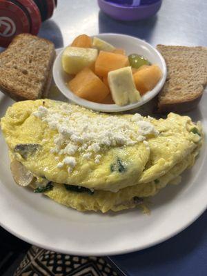 Veggie Omelet add feta cheese with wheat toast and fresh fruit