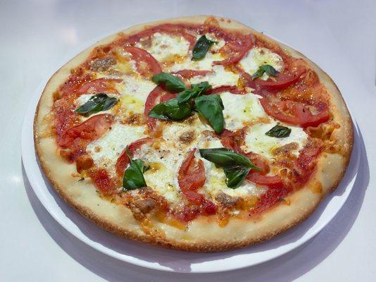 Margarita Pie with fresh mozzarella, sliced tomatoes, fresh basil and EVOO drizzle.