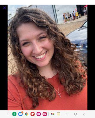 Beautiful curls! Gave this beauty a curly cut. She is able to wear her hair straight as well with beautiful flowing layers! It's the smile!