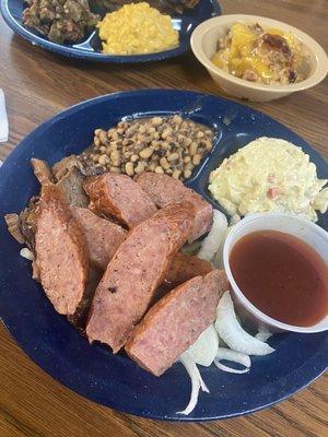 Sausage and Beef plate with collard greens and potato salad. So good!