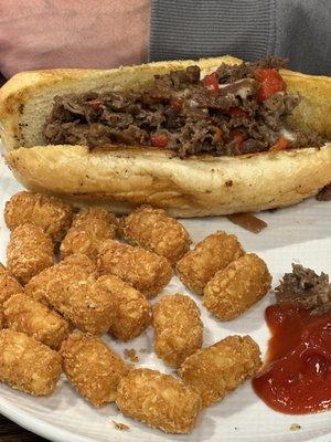 Philly Cheese Steak Sandwich (flavorful!) with tots (crispy outside)