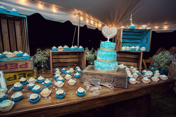 Our Custom Wood Table Tops fit nicely on 2 of our Whiskey Barrels.  Paired with several wooden crates to make this dessert table.