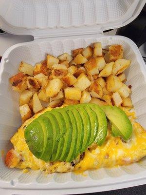 Bacon, tomatoe and avacado omelet, with potatoes.