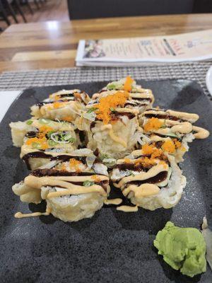 Godzilla!! Cooked Sushi with spicy crab, avocado, cream cheese Tempura style with chef sauce.