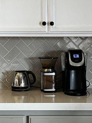 Herringbone 3x6 subway backsplash in color Portico Pearl. Quartz countertop in color Linea.